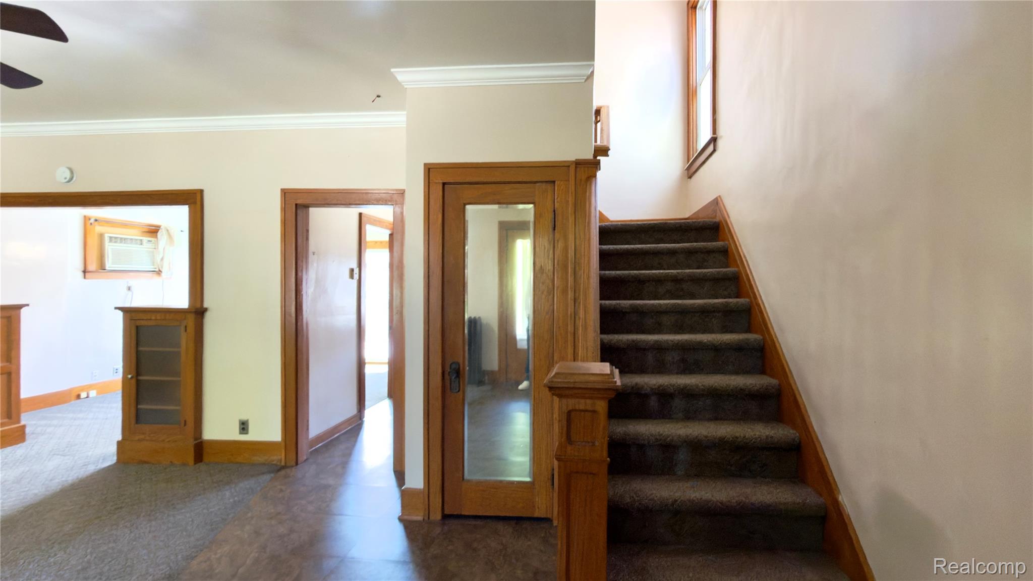 130 Elm Street River Rouge, MI 48218 - Photo 15 of 20 Staircase with wood-finish newel post and railings, carpeted treads, and a window above