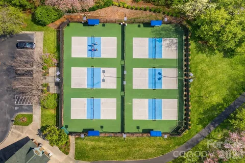 an aerial view of a house with swimming pool and garden