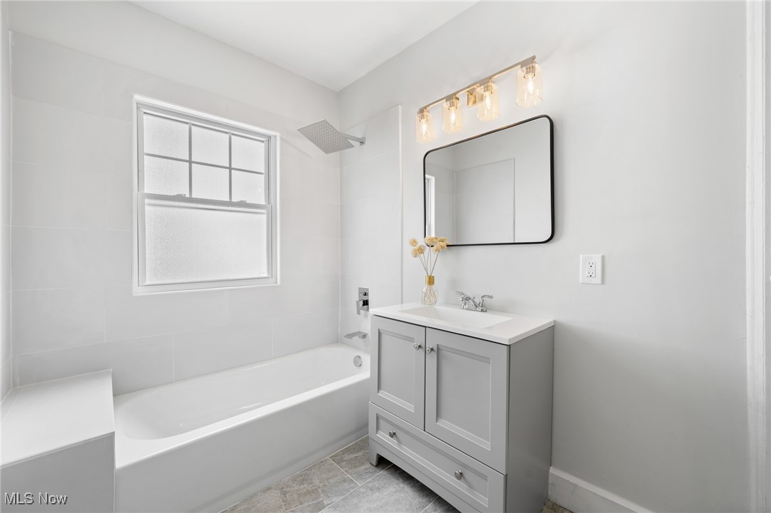 3139 Whitethorn Road Cleveland, OH 44118 - Photo 36 of 50 Bathroom with tile patterned flooring, tiled shower / bath combo, and vanity