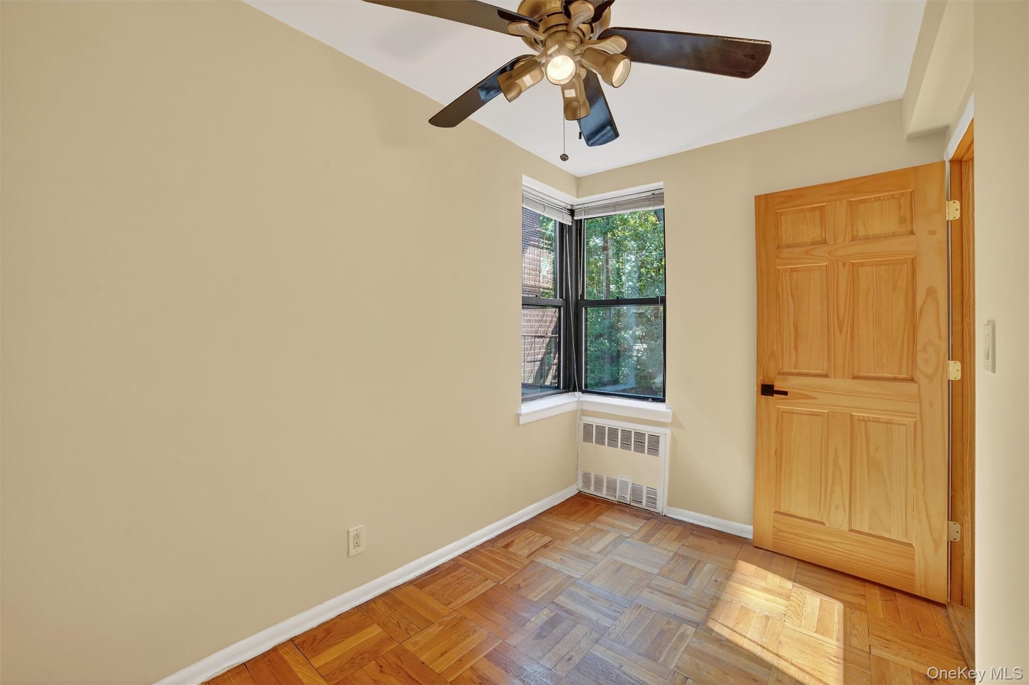 277 Bronx River Road, Unit 5M Yonkers, NY 10704 - Photo 16 of 20 an empty room with a ceiling fan and a window