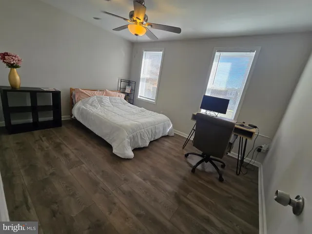 a bedroom with a bed a table and chair