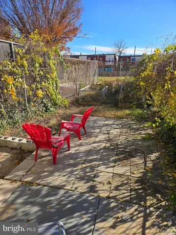 a view of a backyard with sitting area