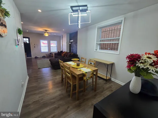 a living room with furniture a potted plant and a chandelier