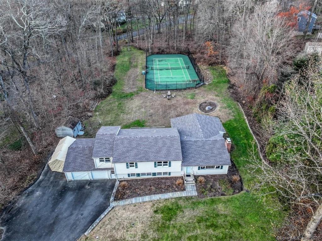 an aerial view of a house with a yard and lake view