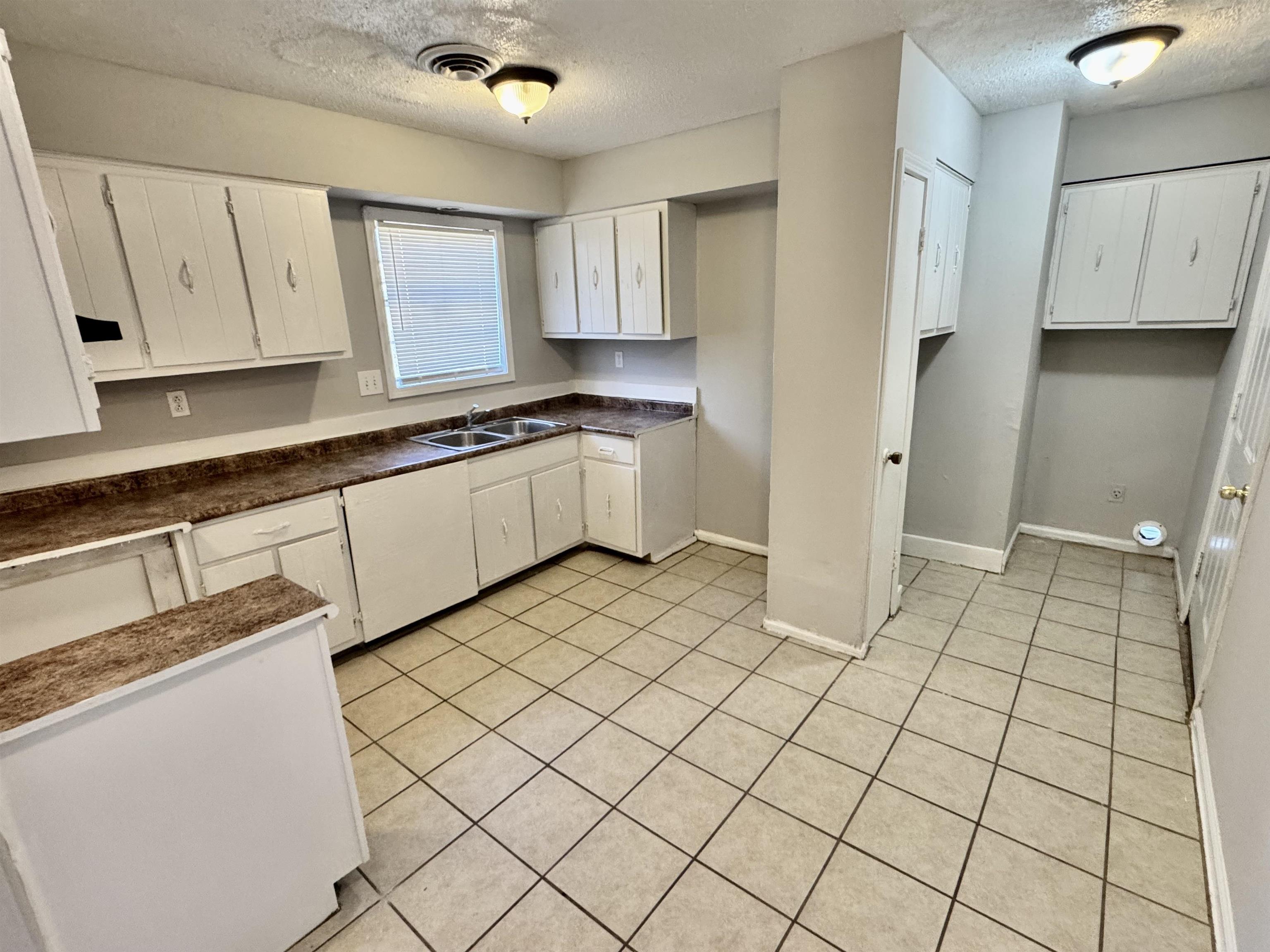 4057 Windermere Road Memphis, TN 38128 - Photo 6 of 14 a kitchen with stainless steel appliances granite countertop a sink and cabinets