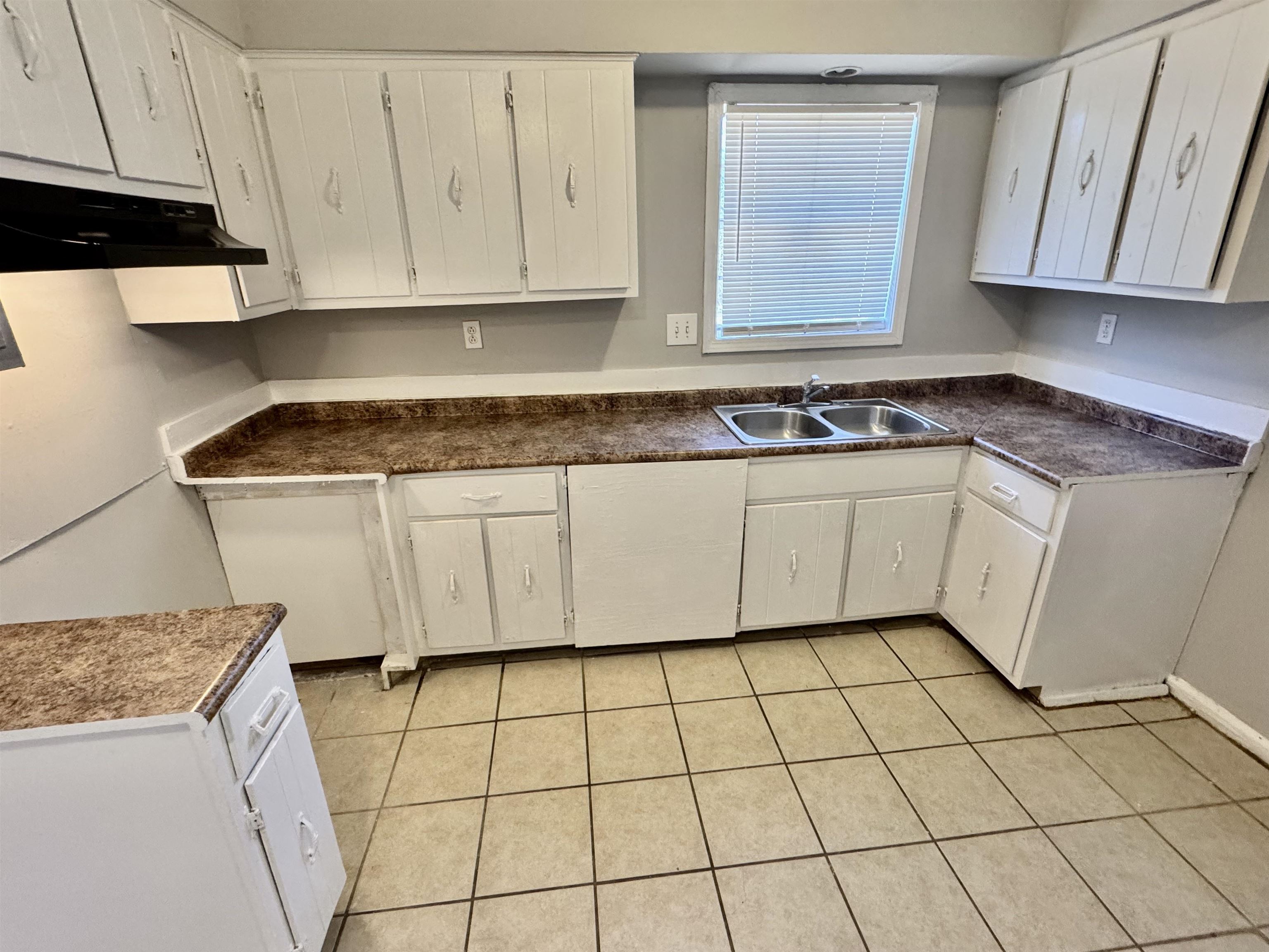 4057 Windermere Road Memphis, TN 38128 - Photo 7 of 14 a kitchen with granite countertop white cabinets and a stove top oven