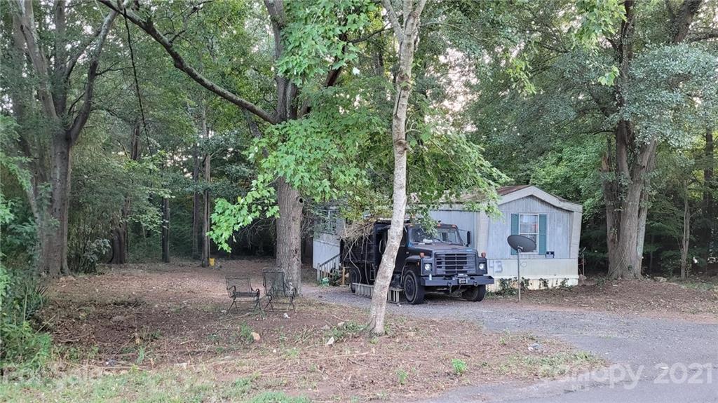843 Archie Street Fort Mill, SC 29715 - Photo 1 of 18 a view of a house with large trees and a small yard