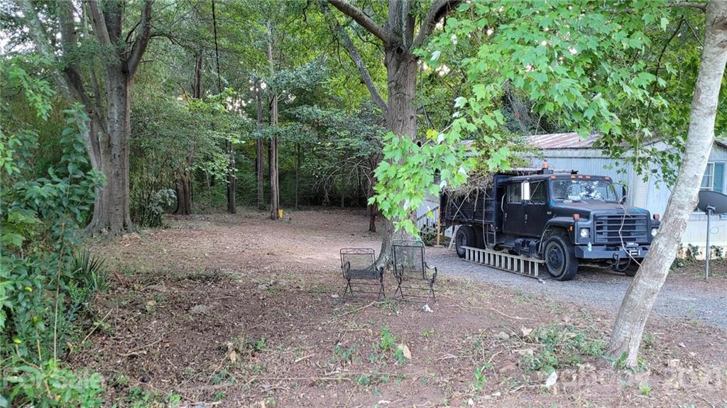 843 Archie Street Fort Mill, SC 29715 - Photo 2 of 18 a view of backyard with outdoor seating and trees