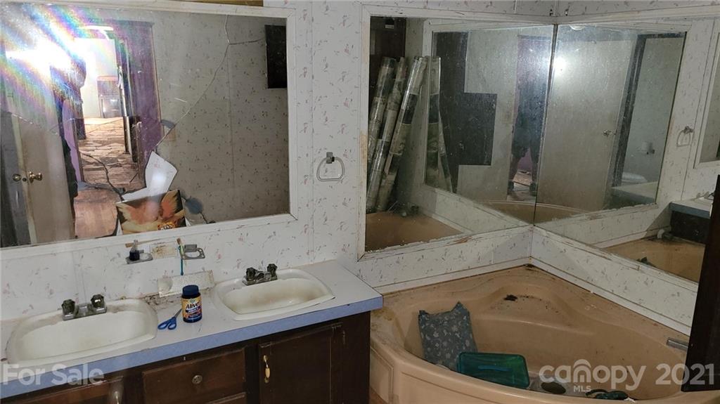 843 Archie Street Fort Mill, SC 29715 - Photo 9 of 18 a bathroom with a tub sink and mirror