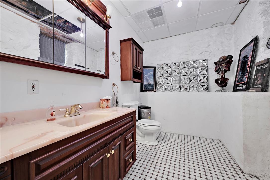 101 Conrad Road Fleetwood, PA 19522 - Photo 19 of 42 White walls and a patterned tile floor create a distinct aesthetic in this well-appointed bathroom.