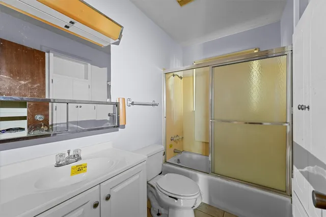 a bathroom with a sink mirror vanity and toilet