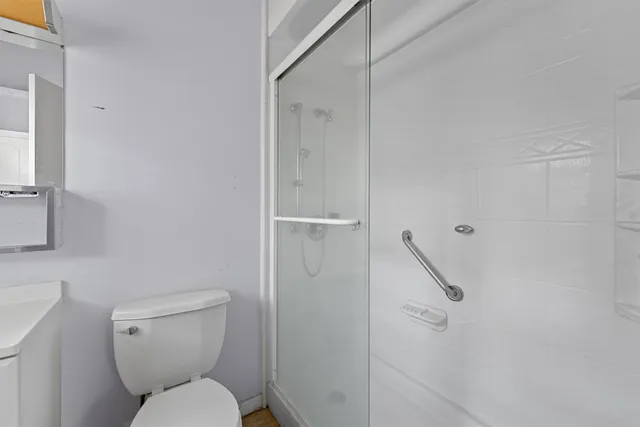 a white toilet sitting next to a bathroom sink