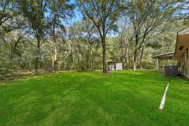a view of house with backyard