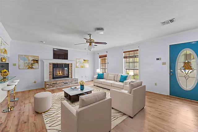 a living room with furniture a flat screen tv and a fireplace