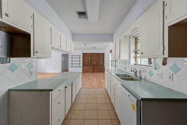a kitchen with granite countertop a sink and cabinets