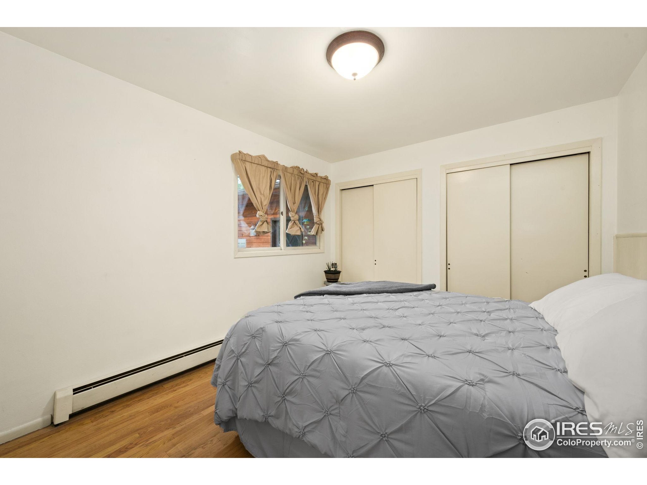 269 Cox Court Bellvue, CO 80512 - Photo 19 of 47 a bedroom with a bed and a painting on the wall