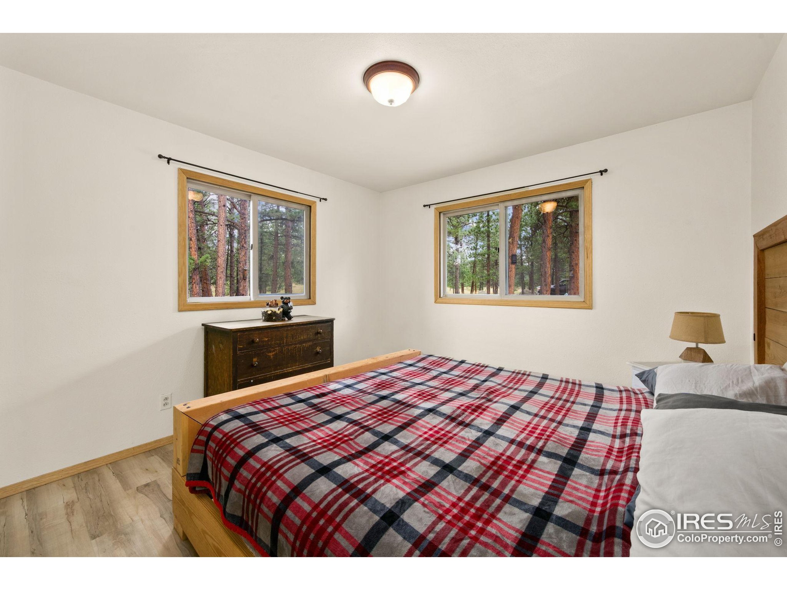 269 Cox Court Bellvue, CO 80512 - Photo 22 of 47 a bedroom with a bed and a table