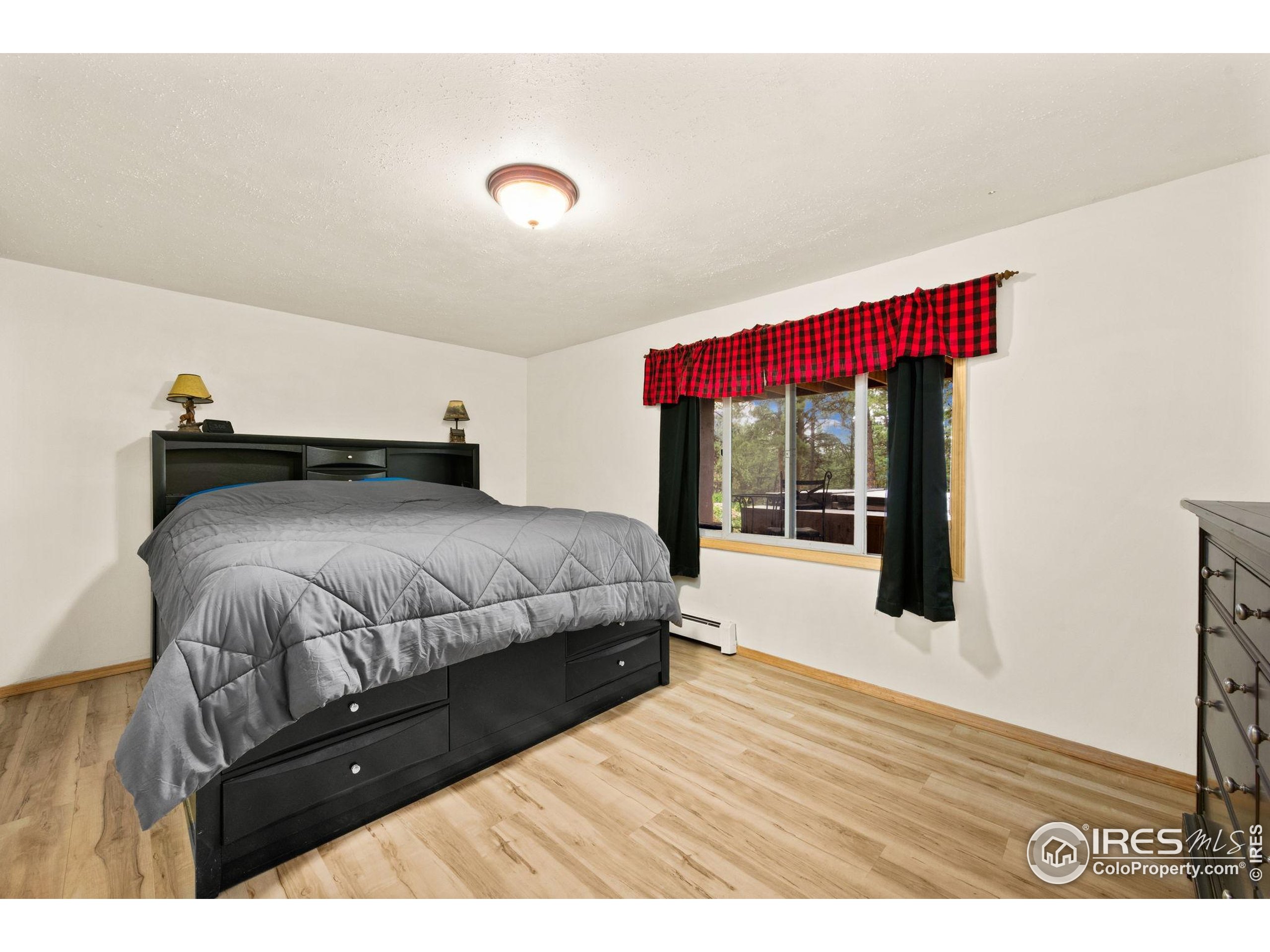 269 Cox Court Bellvue, CO 80512 - Photo 28 of 47 a bedroom with a bed and a large window