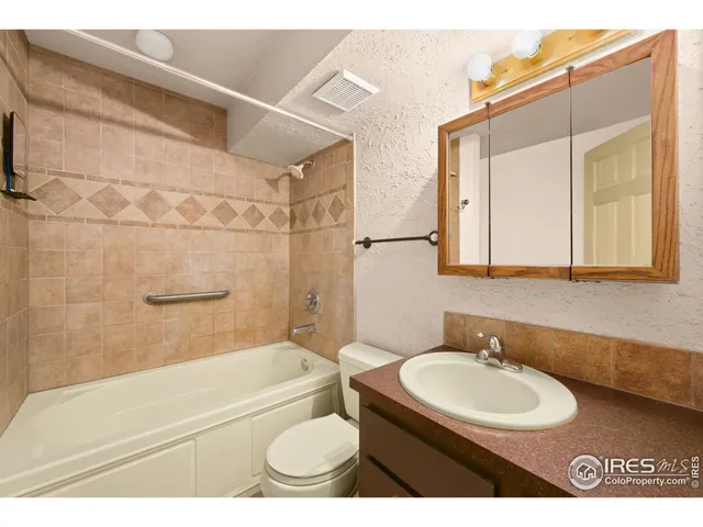 a bathroom with a sink toilet a mirror and shower