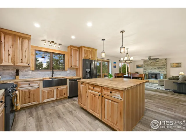 a kitchen with stainless steel appliances granite countertop a stove a sink dishwasher and a oven with cabinets