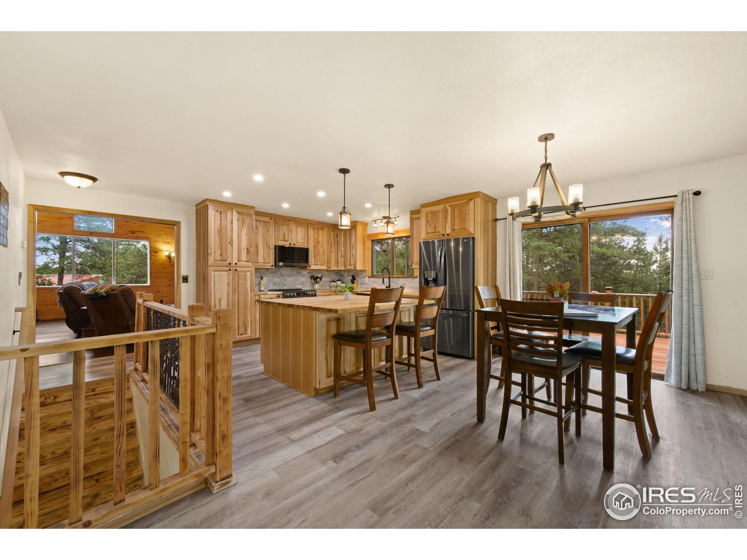269 Cox Court Bellvue, CO 80512 - Photo 10 of 47 a view of a dining room with furniture and wooden floor