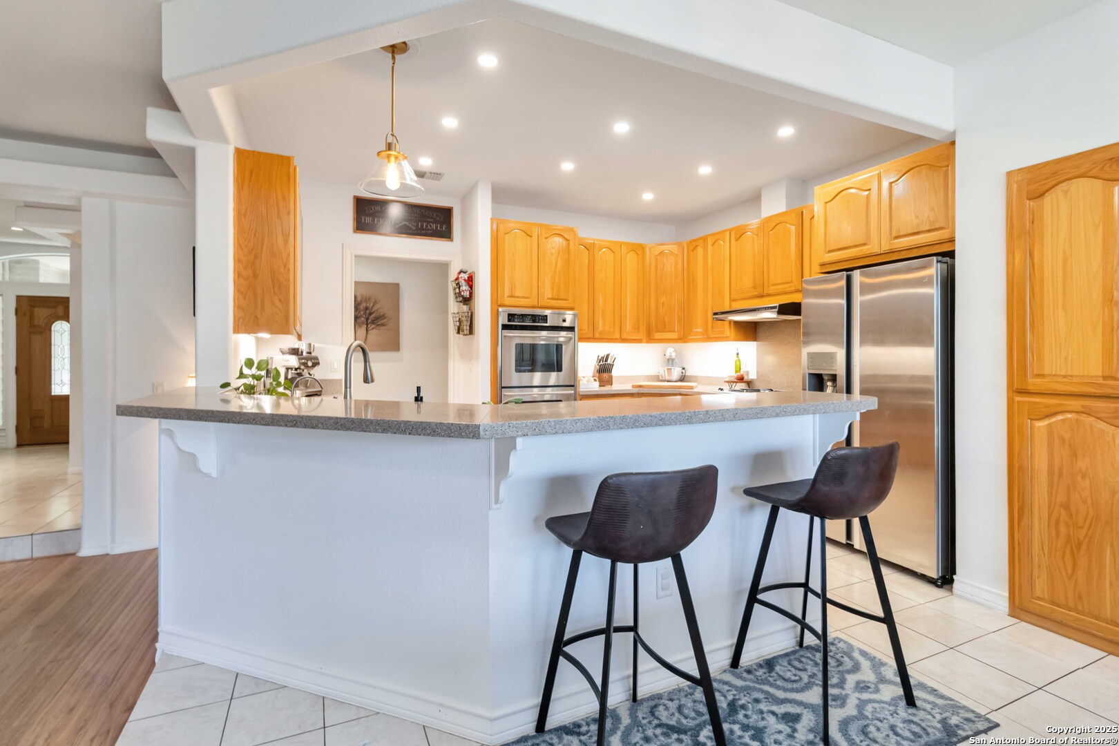 339 Long Meadow Spring Branch, TX 78070 - Photo 16 of 53 a kitchen with stainless steel appliances kitchen island granite countertop a refrigerator and cabinets