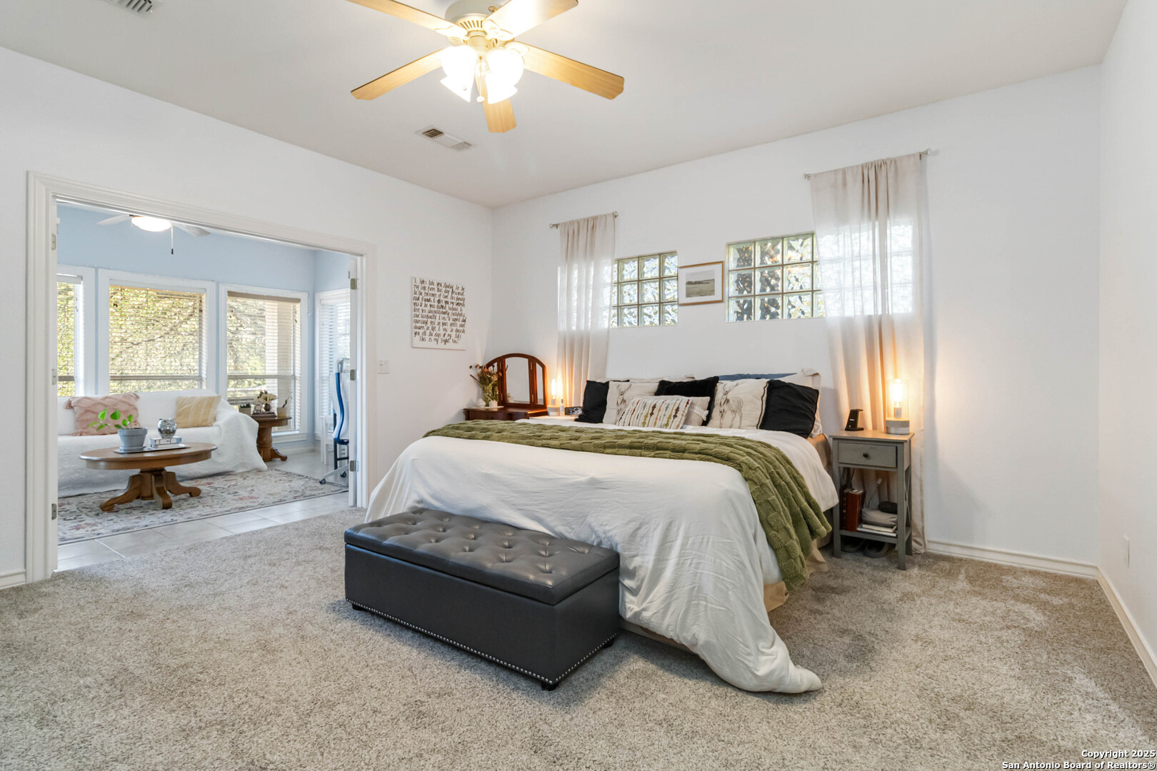 339 Long Meadow Spring Branch, TX 78070 - Photo 27 of 53 a spacious bedroom with a bed and a chandelier