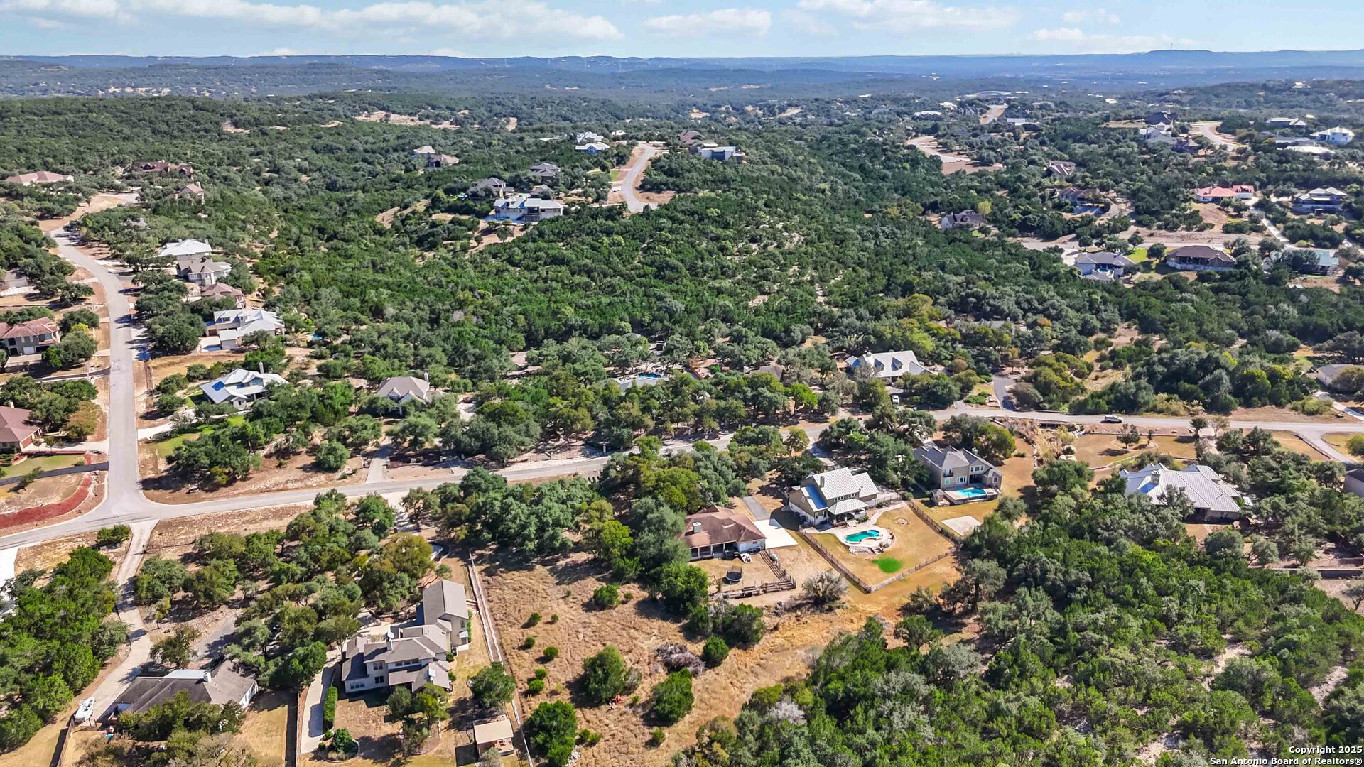 339 Long Meadow Spring Branch, TX 78070 - Photo 47 of 53 an aerial view of a houses with a lush green hillside
