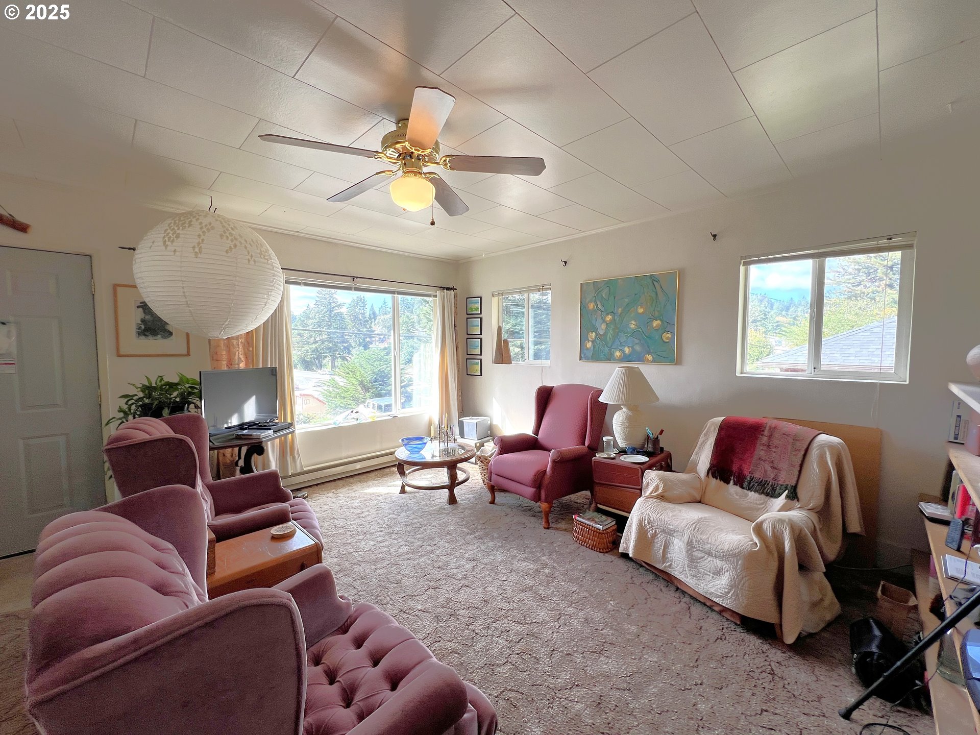 860 8th Terrace Coos Bay, OR 97420 - Photo 6 of 22 a living room with furniture ceiling fan and a window