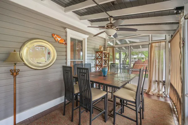 a view of a deck with wooden floor and fence next to a yard