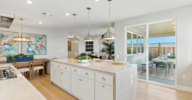 a kitchen with white cabinets and appliances