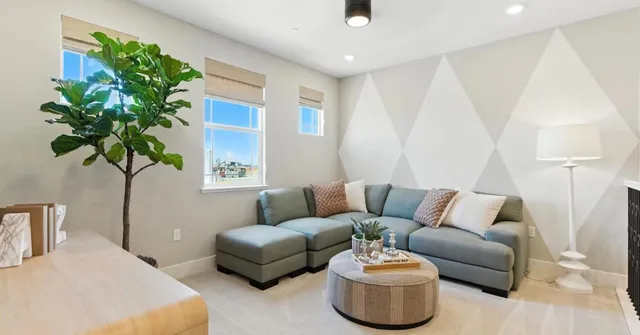 a spacious bedroom with a bed and a view of cabinet