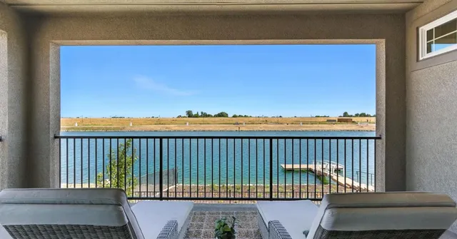 a view of a patio with table and chairs and potted plants with wooden fence