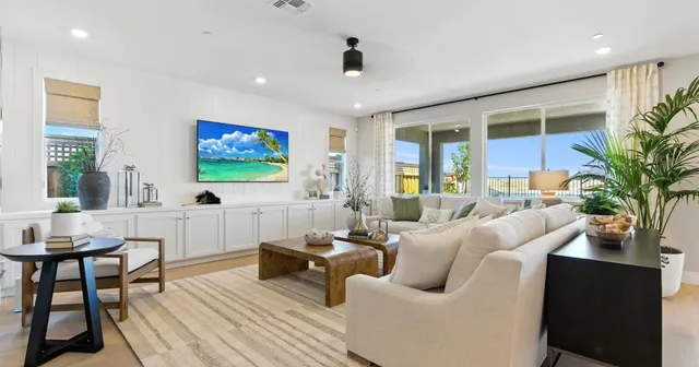 a kitchen with stainless steel appliances kitchen island granite countertop a table chairs sink and cabinets