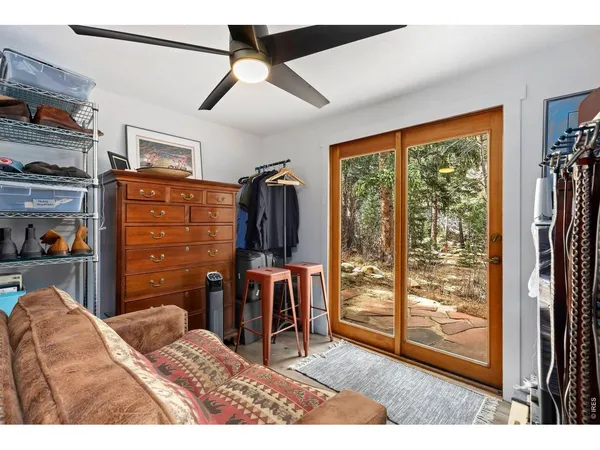 a bedroom with furniture and a large window