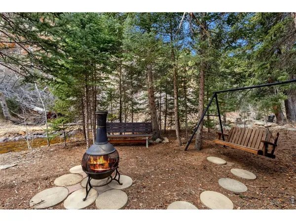 a backyard of a house with barbeque oven table and chairs