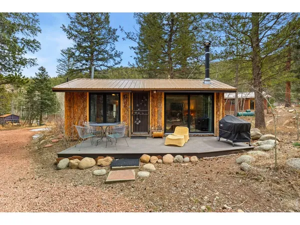 a view of a house with backyard porch and sitting area