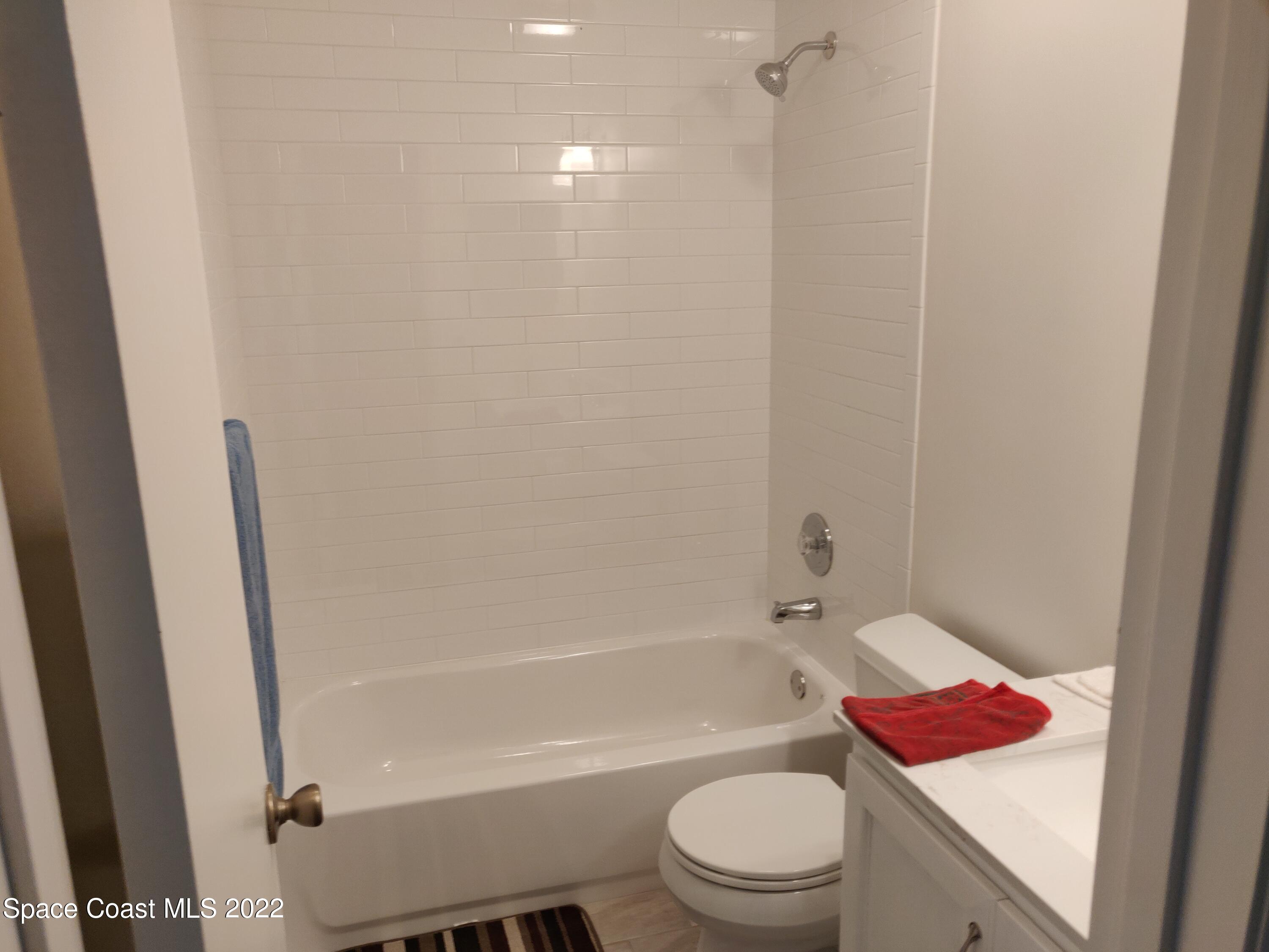 3649 Longbow Road Cocoa, FL 32926 - Photo 12 of 34 a bathroom with a toilet and a bathtub