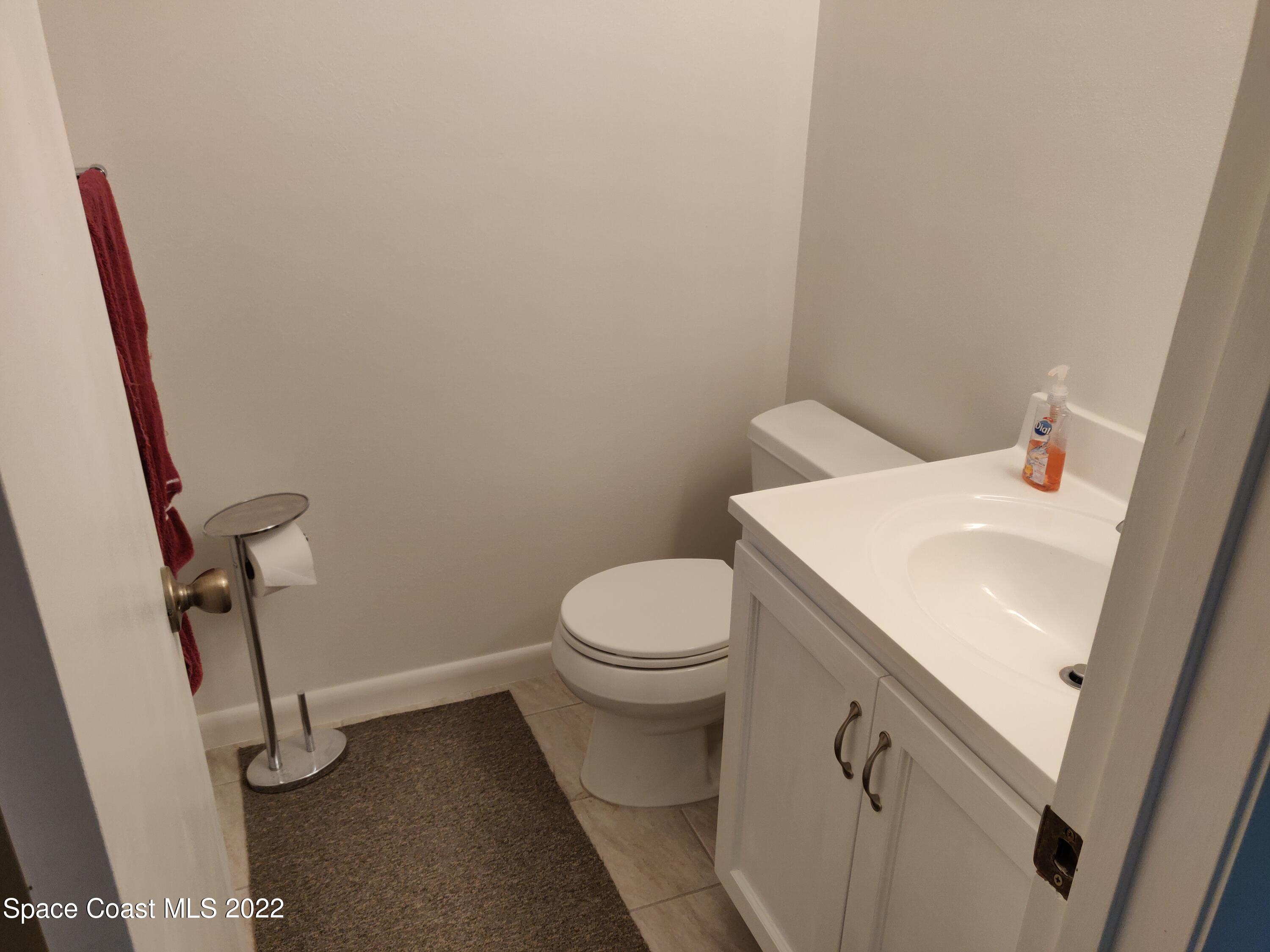 3649 Longbow Road Cocoa, FL 32926 - Photo 13 of 34 a bathroom with a sink and a toilet
