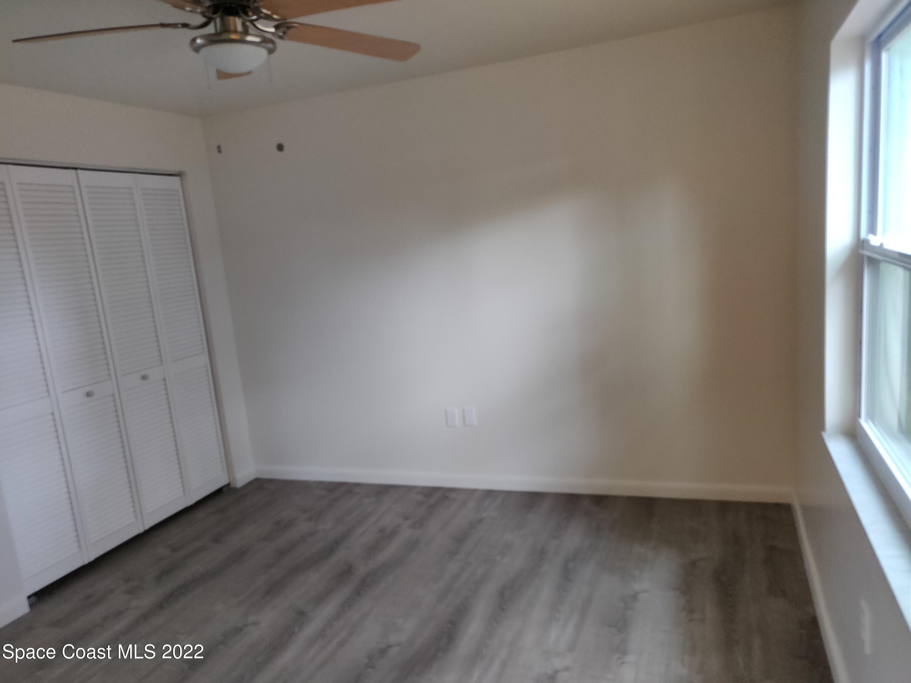 3649 Longbow Road Cocoa, FL 32926 - Photo 14 of 34 a view of a room with a window and a ceiling fan
