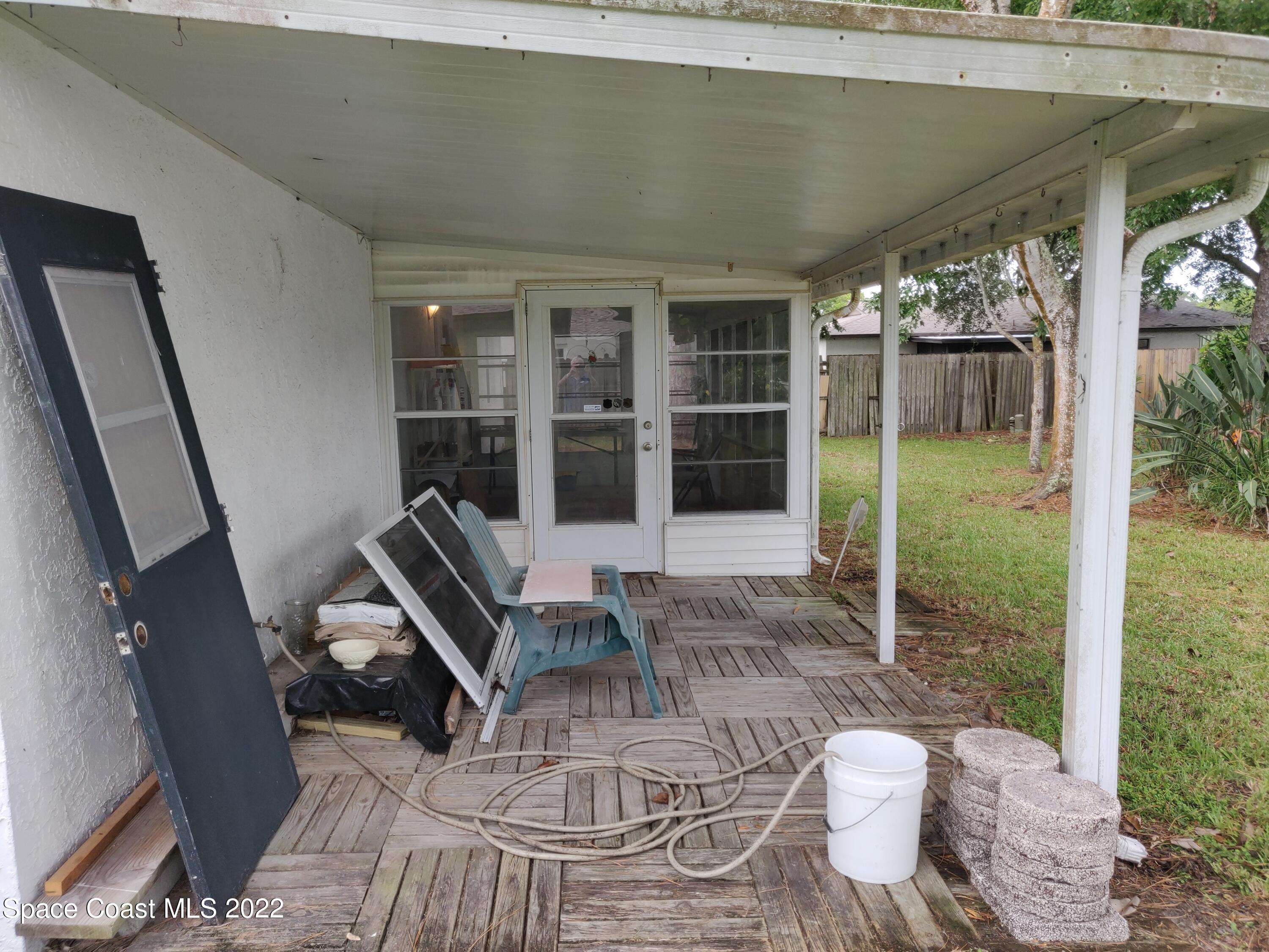 3649 Longbow Road Cocoa, FL 32926 - Photo 23 of 34 a view of a porch with chairs and backyard