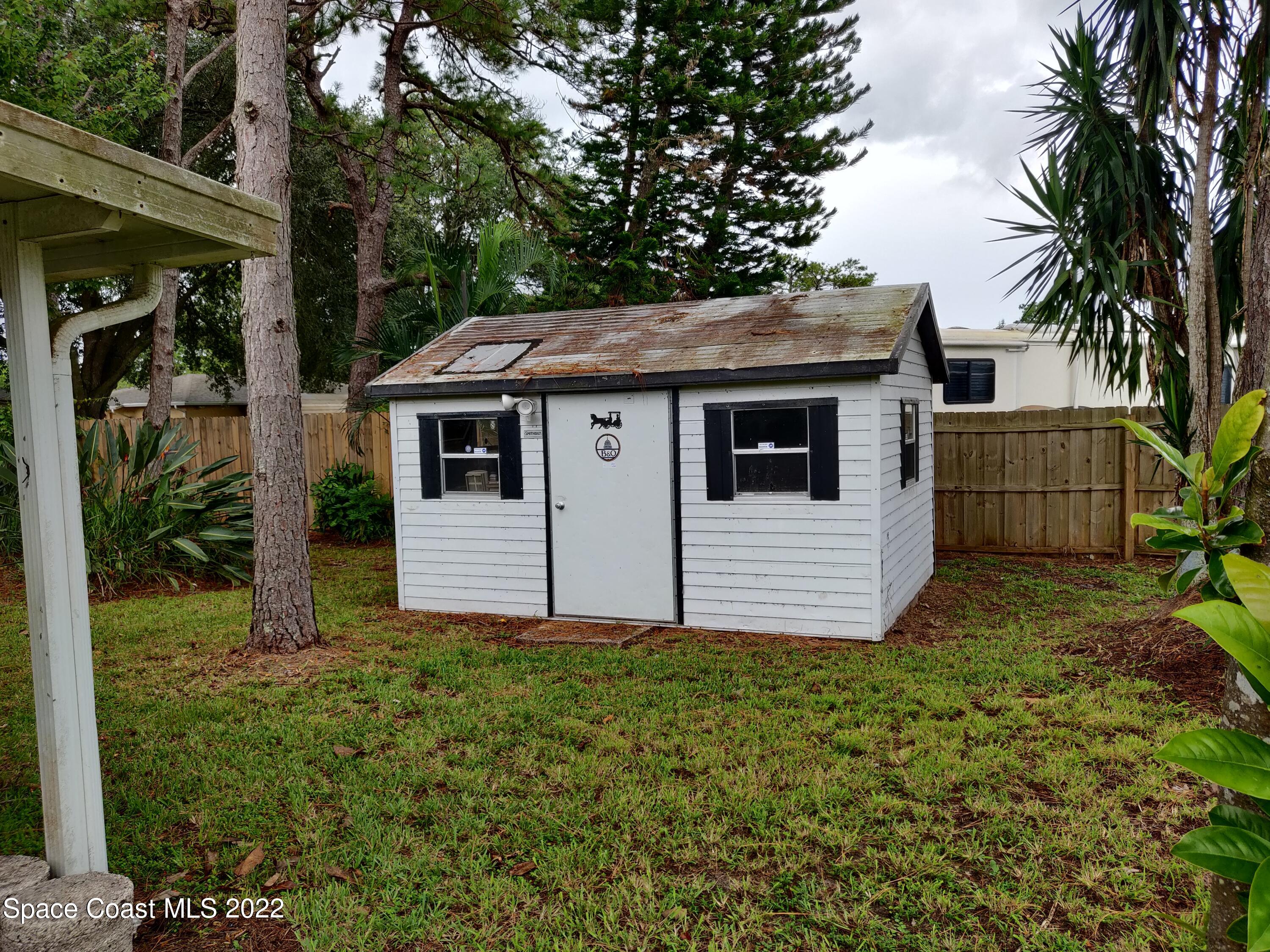 3649 Longbow Road Cocoa, FL 32926 - Photo 27 of 34 a view of a house with a yard