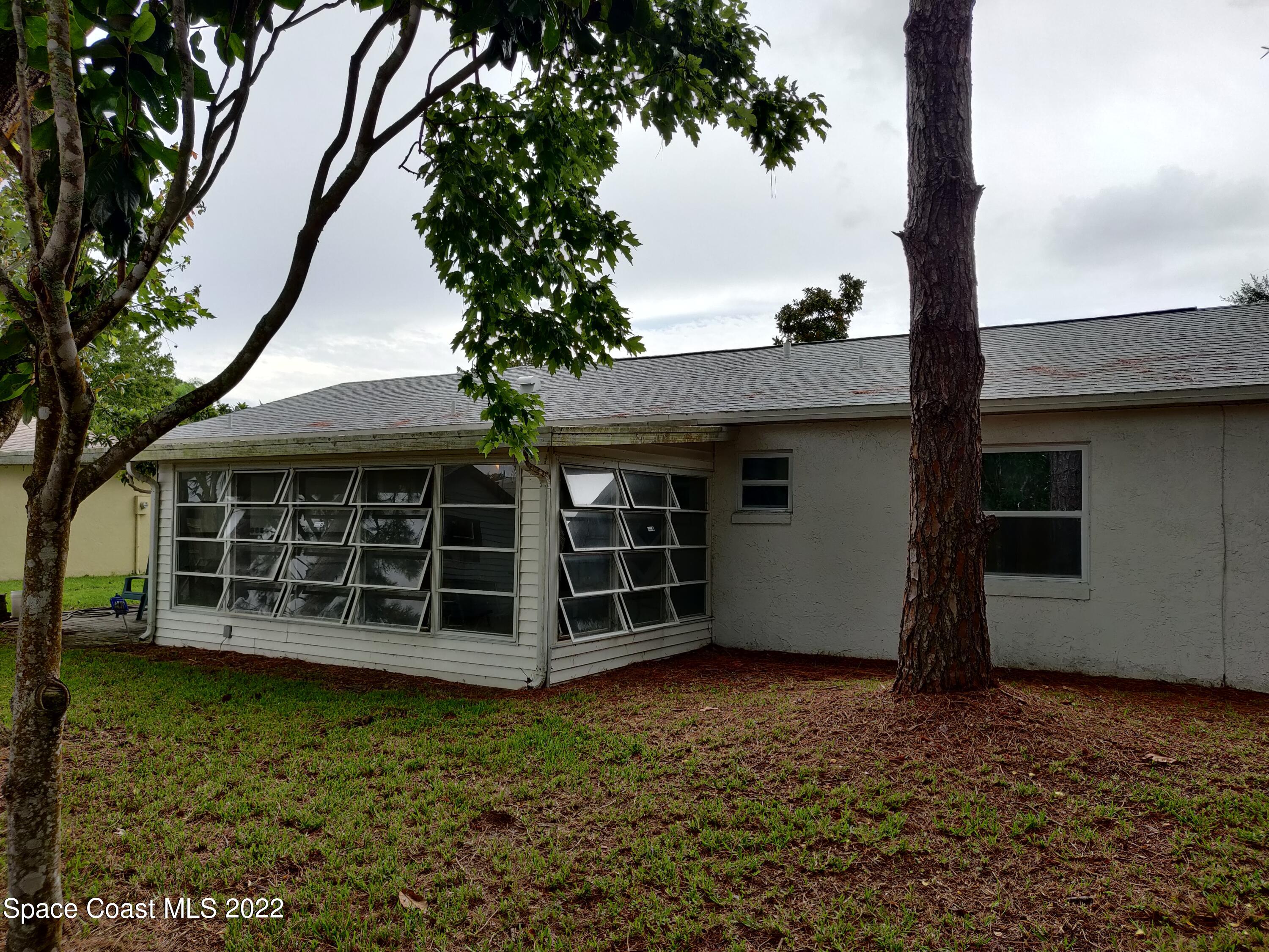 3649 Longbow Road Cocoa, FL 32926 - Photo 29 of 34 a view of a house with a yard