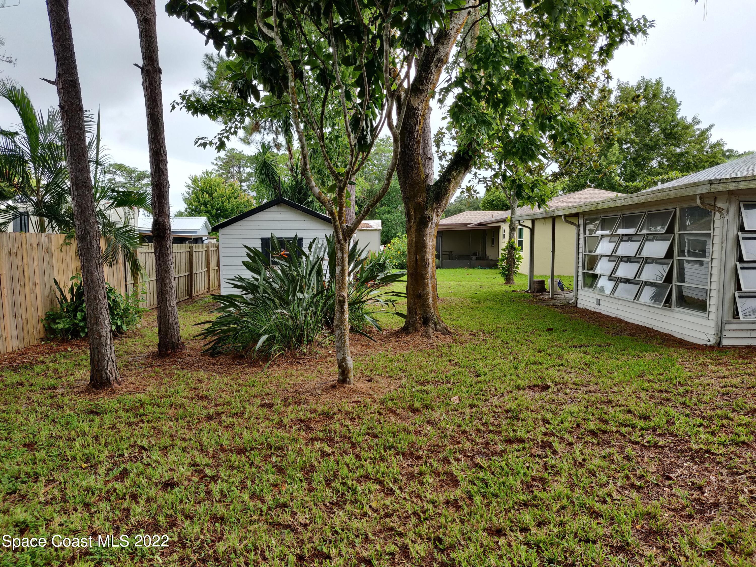3649 Longbow Road Cocoa, FL 32926 - Photo 30 of 34 a view of a house with a yard