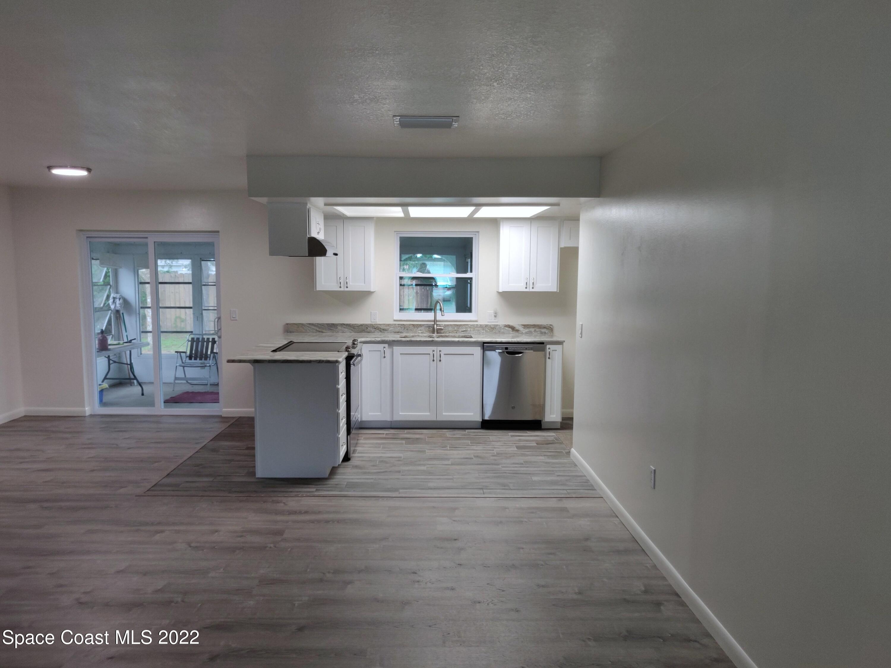 3649 Longbow Road Cocoa, FL 32926 - Photo 3 of 34 a view of a kitchen with a sink cabinets and window