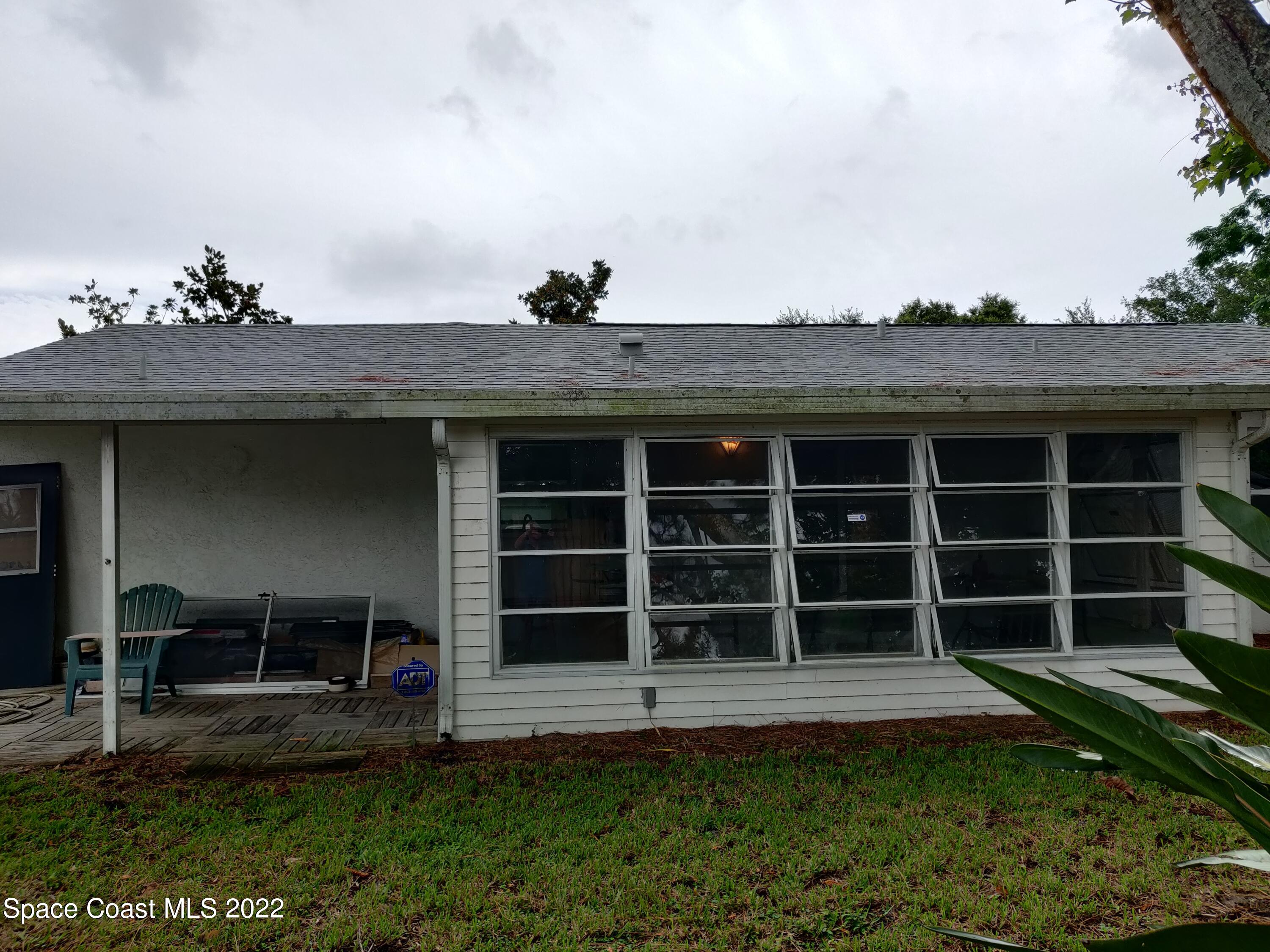 3649 Longbow Road Cocoa, FL 32926 - Photo 31 of 34 a front view of a house with a yard