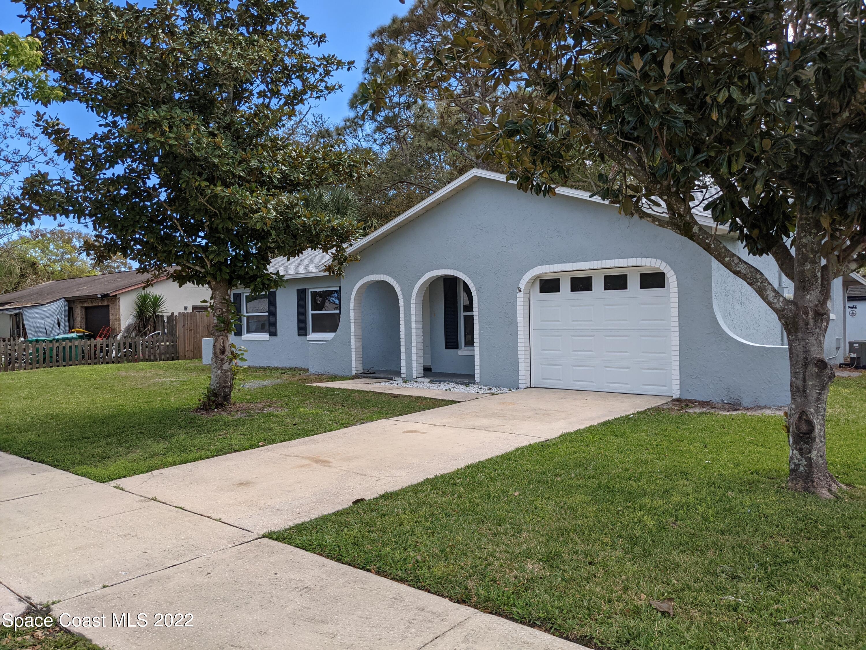 3649 Longbow Road Cocoa, FL 32926 - Photo 34 of 34 a front view of a house with a yard