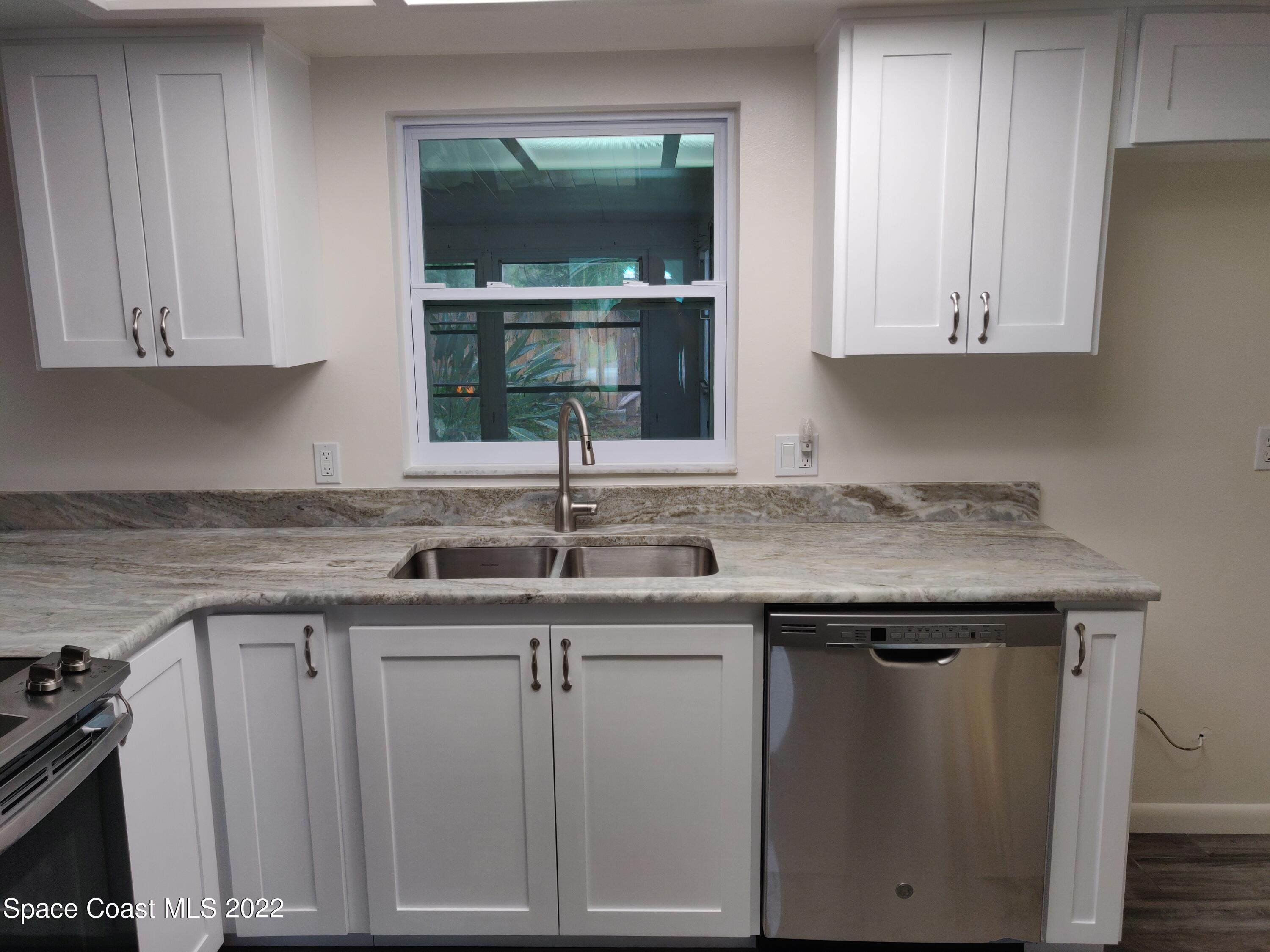 3649 Longbow Road Cocoa, FL 32926 - Photo 7 of 34 a kitchen with a sink and cabinets