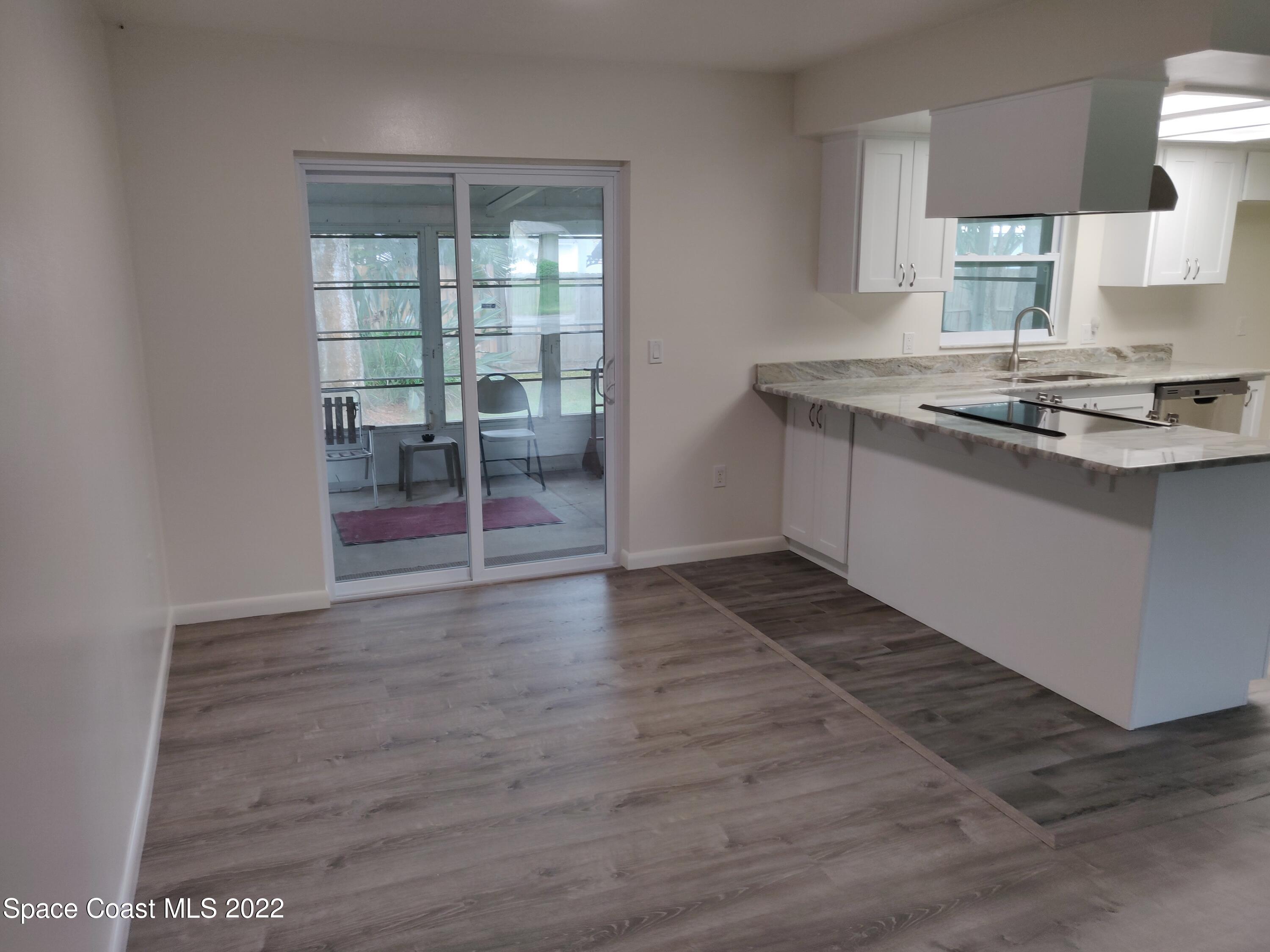3649 Longbow Road Cocoa, FL 32926 - Photo 10 of 34 a room with wooden floor and window