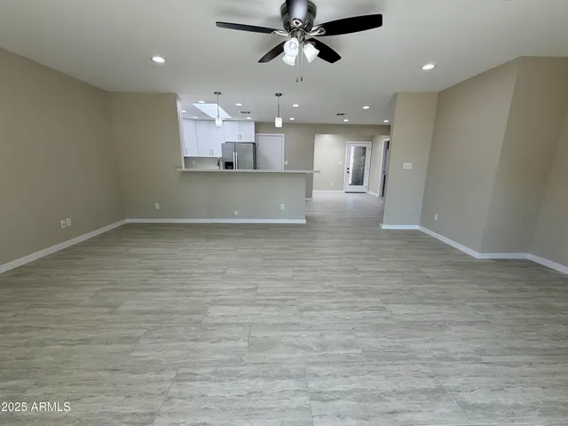 an empty room with windows and cabinet